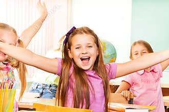 Happy Girl with arms apart laughs during lesson