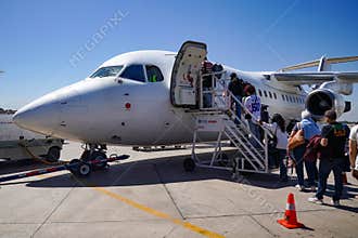 Passengers board an Aerovias DAP British Aerospace BAe 146 regional airliner at Arturo Merino Bentez International Airport