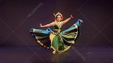 Traditional Javanese Dancer Displaying Flowing Costume in Elegant Stage Performance