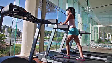 Woman running on treadmill in gym