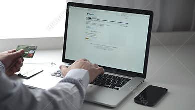 Men use Paypal on macbook