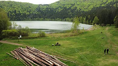 Aerial drone view of a crater lake with a wooden dock and floating pla