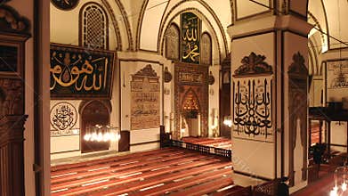 Ornate mihrab and Islamic decoration glow inside Bursa Ulu Cami at night in Turkiye, mosque, interior, ulu camii, camii