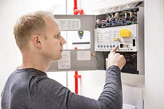 Technician checks fire panel in data center