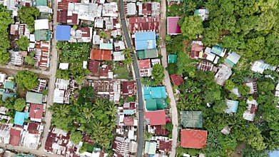 Push-in Bird-eye view shot of a shanty town along a creek in the Philippines. The aerial f