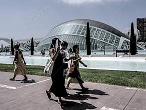 People going about their daily lives in the streets of the city of Valencia