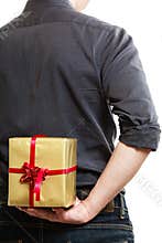 Holiday. Man hiding surprise gift box behind back
