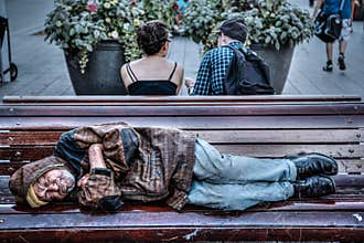 Homeless Senior Man Sleeping on Park Bench