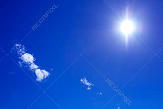 Sun and clouds on blue sky