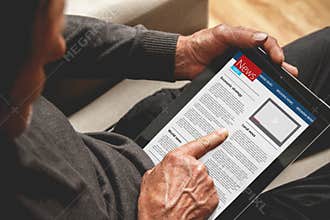 Senior holding a tablet in hands