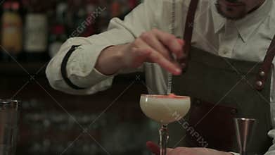 Bartender hands making and decorating cocktail