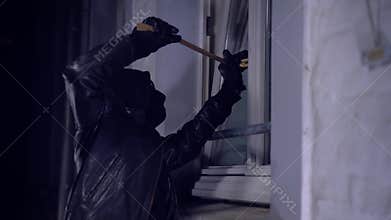 Intruder or burglar with crowbar