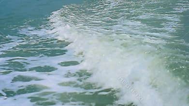 Wave create by engine propellers churn the water into waves and wakes