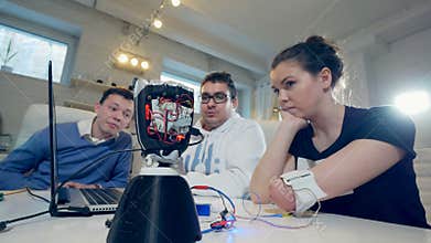 Woman with innovative cybernetic bionic arm. Disabled woman operates modern bionic prosthesis.