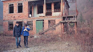 Children refugees against the backdrop of bombed houses. war