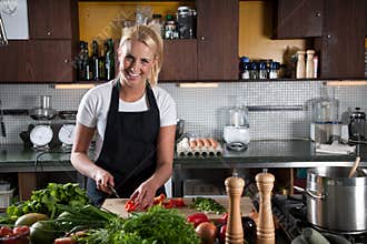 Happy female chef in the kitchen