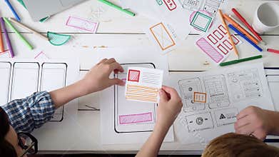 Small team of UX designers creating mobile app layout