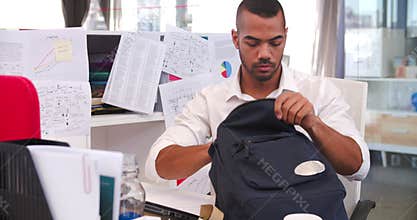 Businessman Arriving In Office And Sitting At Desk