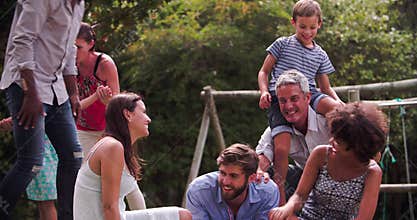 Group Of Families Playing In Garden Together