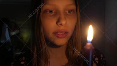 Scared girl with a candle