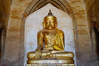 Golden Buddha statue at the Thatbyinnyu Temple in Bagan, Myanmar