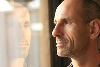 Man in thought with window reflection