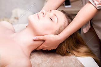 Caucasian pretty woman having massage in spa salon