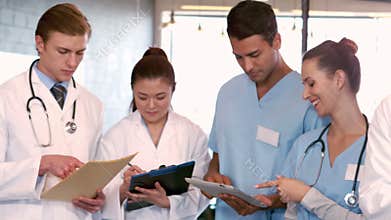 Doctors and nurses writing notes on clipboards