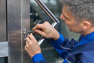 Male Lockpicker Fixing Door Handle At Home