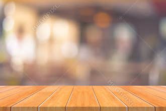 Wooden board empty table in front of blurred background. Perspective brown wood over blur in restaurant - can be used for display