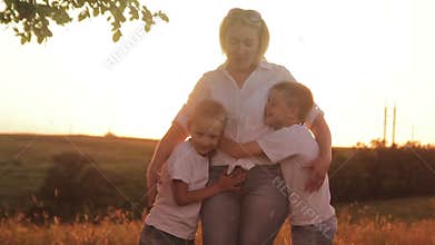 Happy family of three people. Children playing outdoors with their parents.
