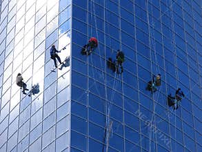 Six workers washing windows