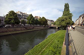 Tourists walking along a river in Strasbourg