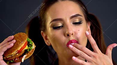 Girl eating hamburger.