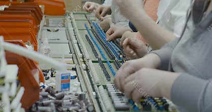 Workers manually assemble Electronic parts on PCB