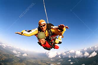 Smiling skydivers mid air