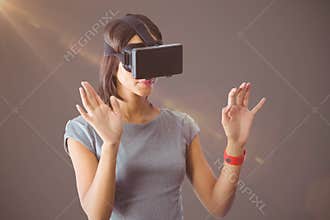 Composite image of businesswoman holding virtual glasses on a grey background