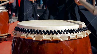 Musicians drummers play taiko drums chu-daiko outdoors. Culture folk music of Asia Korea, Japan, China.