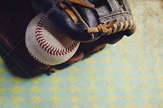 Old vintage ball in leather mitt, grunge baseball equipment image. Great for sports team or hardball player graphic.