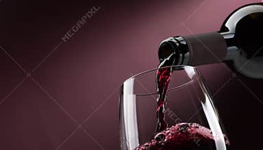 Pouring red wine into a wineglass