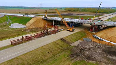 Bridge construction. Sky view of crawler crane repair bridge over highway road