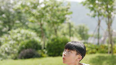 Asian little kid shooting basketball outdoor slow motion