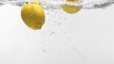 Two lemons drop on water,Slow motion