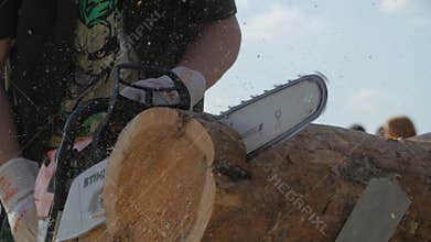 Chainsaw cutting trunk. Man with chainsaw cutting the tree. Chainsaw to cut firewood close up. Man cutting a branch with