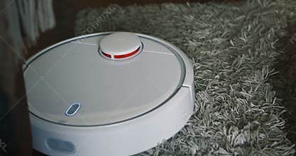 Robot vacuum cleaner on carpet floor, Smart robotic automate wireless cleaning technology machine in living room