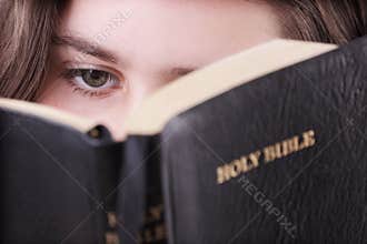 Girl reading the holy bible
