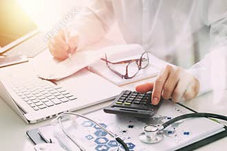 Healthcare costs and fees concept.Hand of smart doctor used a ca