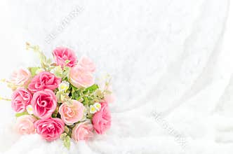 Pastel Coloured Artificial Pink Rose on white fur background