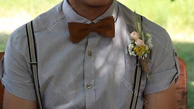 Man corrects clothing accessories