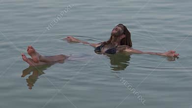 Young Woman floating on the Dead Sea, Israel